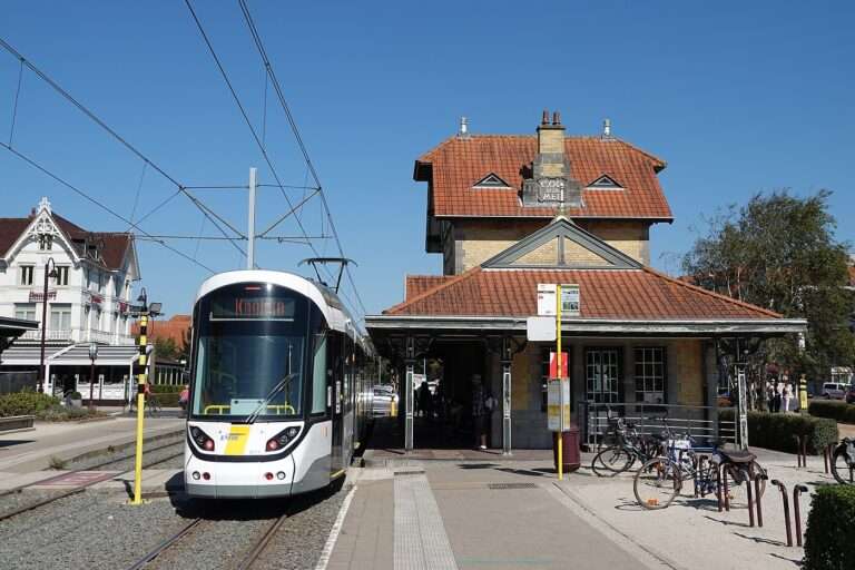 A coastal tram at De Haan's belle-époque tram station with villas behind