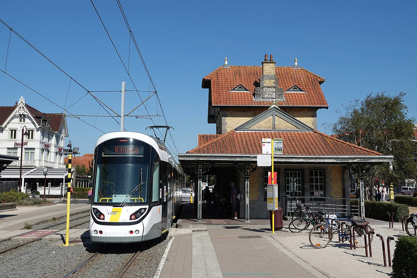 A coastal tram at De Haan's belle-époque tram station with villas behind